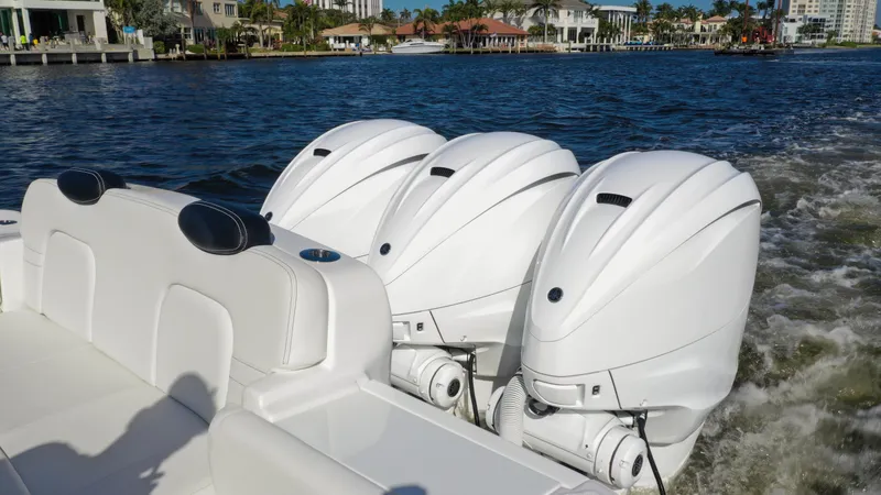 Slide: The Image of 2022 HCB 42 Lujo boat with triple outboard engines cruising on a sunny day. - 19