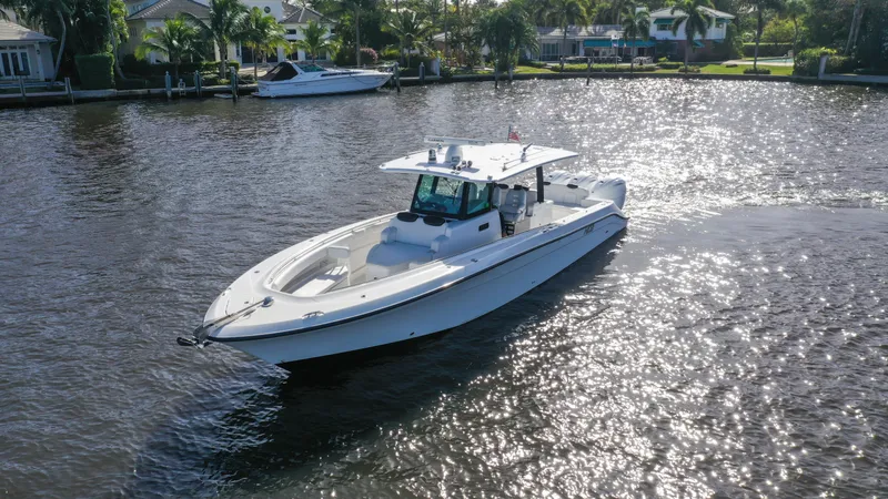 Slide: The Image of 2022 HCB 42 Lujo boat cruising on a sunny waterway. - 2