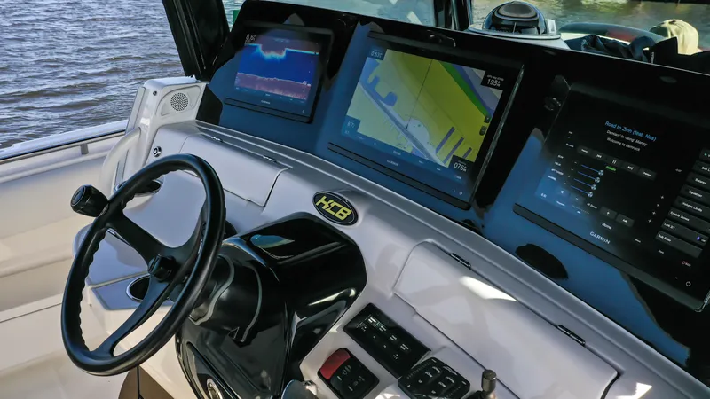 Slide: The Image of 2022 HCB 42 Lujo boat dashboard with advanced navigation screens. - 23