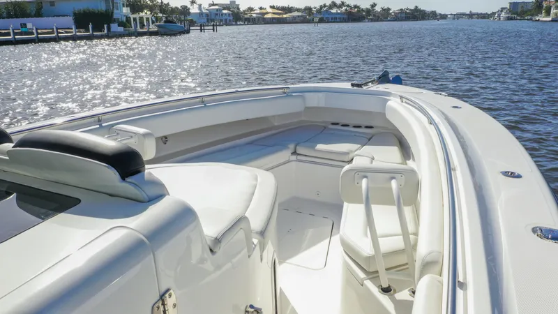 Slide: The Image of 2022 HCB 42 Lujo boat on a sunny waterway, showcasing sleek design and spacious seating. - 28