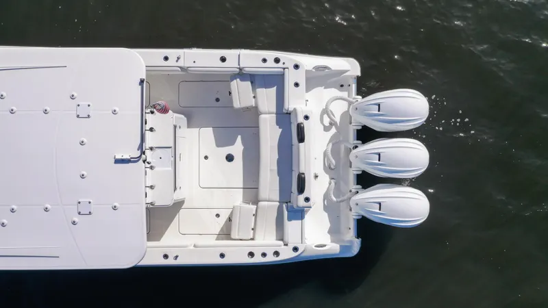 Slide: The Image of Aerial view of 2022 HCB 42 Lujo boat with triple outboard engines. - 6