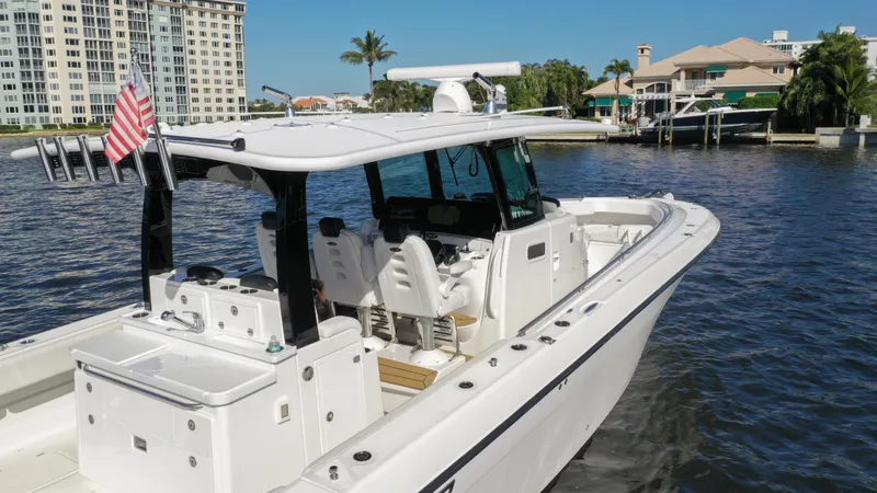 Slide: The Image of 2022 HCB 42 Lujo boat docked in a marina with waterfront buildings. - 8