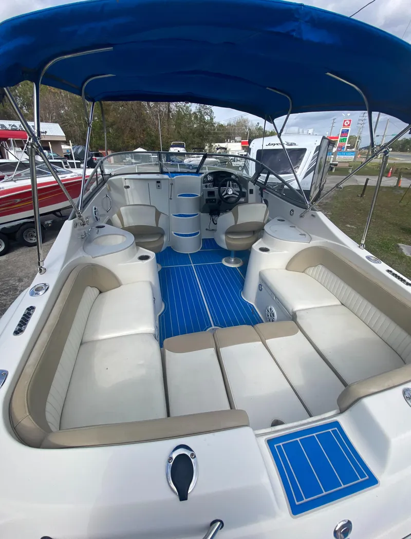Slide: The Image of 2019 Stingray 250CR boat with blue canopy and spacious seating. - 10