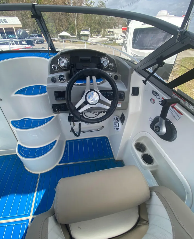 Slide: The Image of 2019 Stingray 250CR boat cockpit with steering wheel and blue flooring. - 11