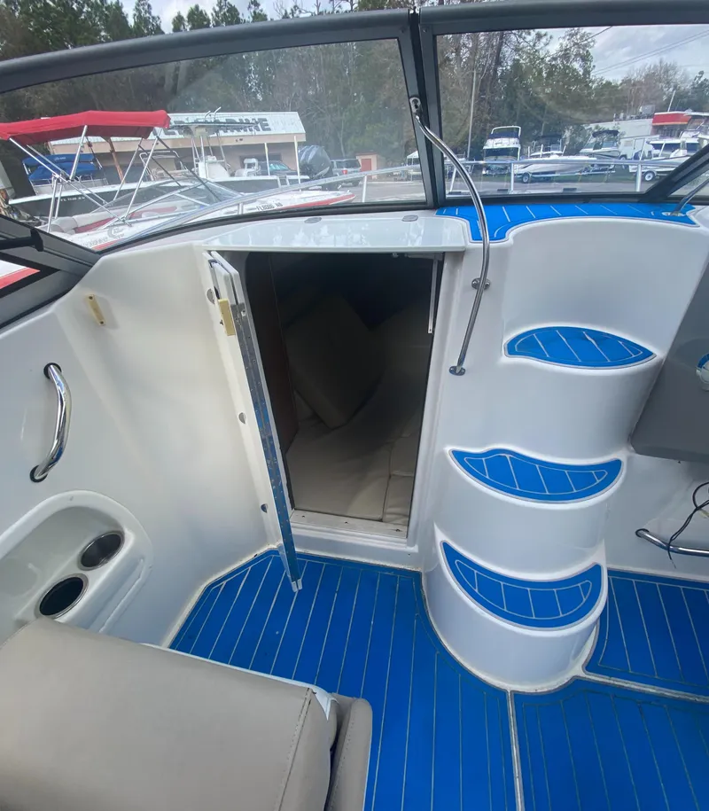 Slide: The Image of 2019 Stingray 250CR boat interior with blue accents and cabin entrance. - 13