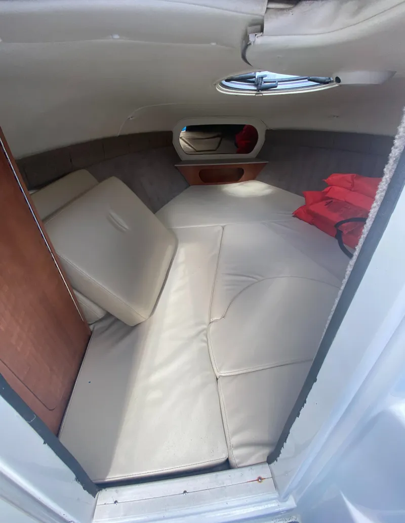 Slide: The Image of 2019 Stingray 250CR cabin interior with beige seating and red life jackets. - 14