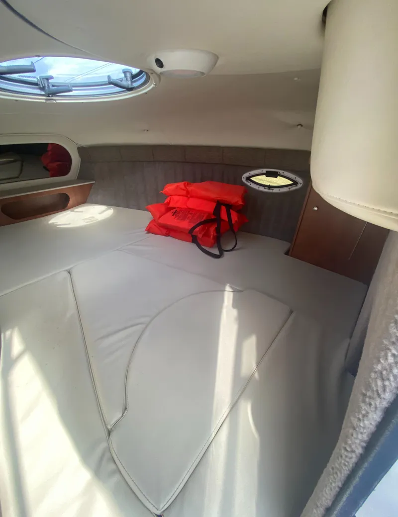 Slide: The Image of Interior cabin of 2019 Stingray 250CR boat with life jackets on bed. - 15