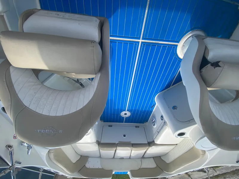 Slide: The Image of 2019 Stingray 250CR boat interior with beige seating and blue flooring. - 5