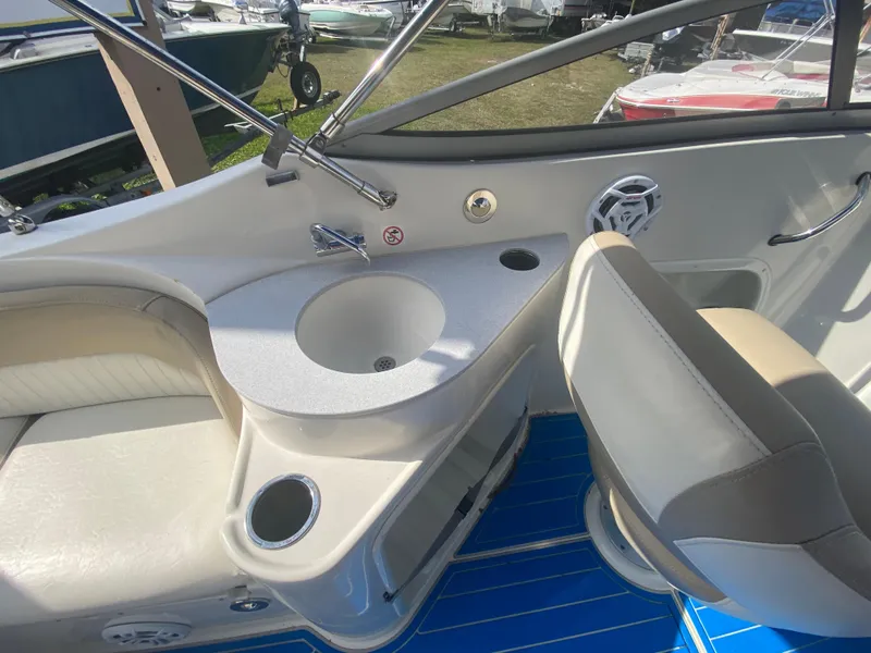 Slide: The Image of 2019 Stingray 250CR boat interior with sink, seating, and blue flooring. - 6