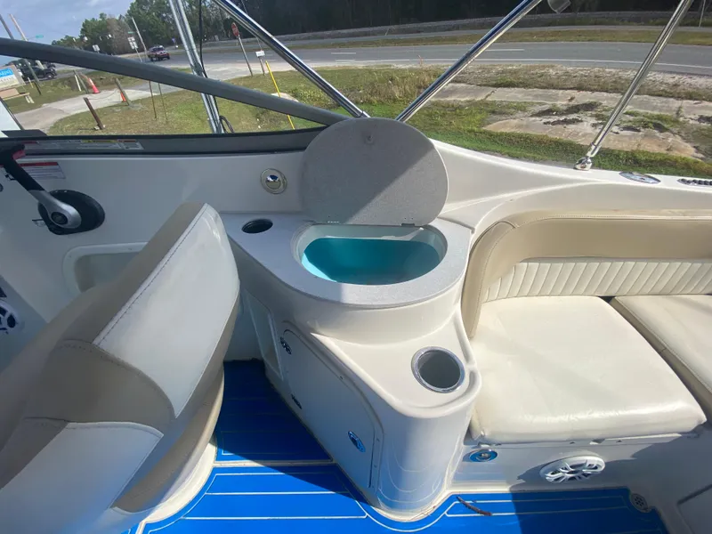 Slide: The Image of 2019 Stingray 250CR boat interior with seating and built-in sink. - 7