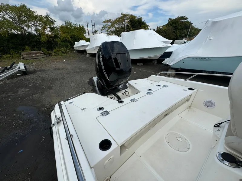 Slide: The Image of 2019 Boston Whaler 240 Dauntless boat with outboard motor in storage yard. - 3