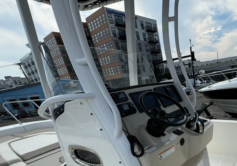 Slide: The Image of 2019 Boston Whaler 240 Dauntless boat console with urban background. - 5