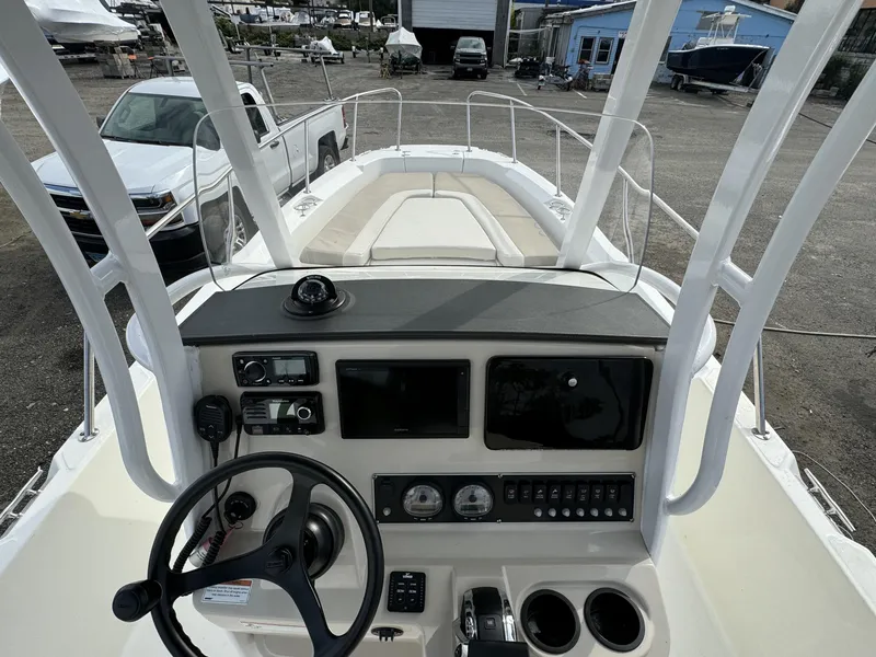 Slide: The Image of 2019 Boston Whaler 240 Dauntless boat dashboard with steering wheel and controls. - 6