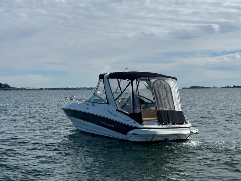 Slide: The Image of 2020 Crownline 286 SC boat on calm water under cloudy sky. - 2