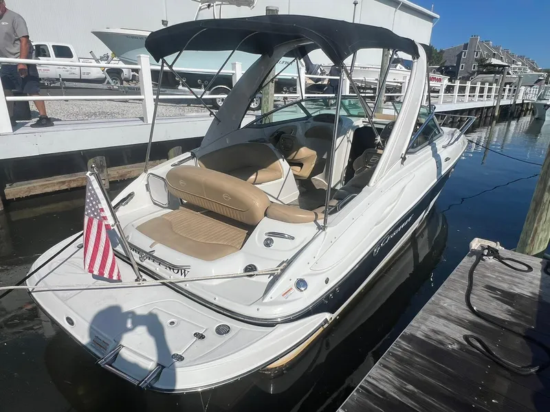 Slide: The Image of 2020 Crownline 286 SC boat docked, featuring a sleek design and American flag. - 3