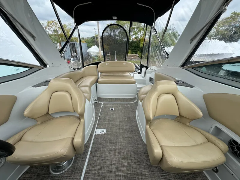 Slide: The Image of 2020 Crownline 286 SC boat interior with beige seating and canopy. - 4