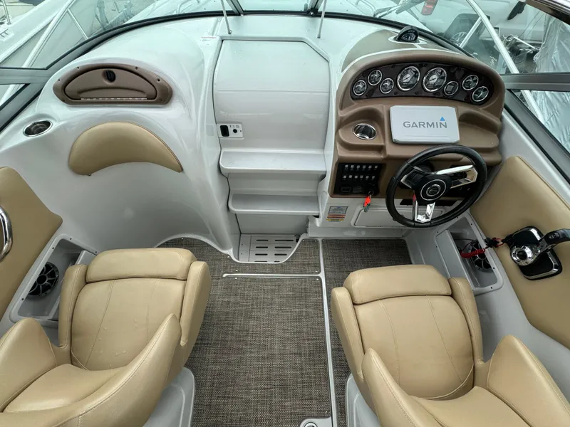 Slide: The Image of 2020 Crownline 286 SC boat interior with beige seats and Garmin navigation system. - 5