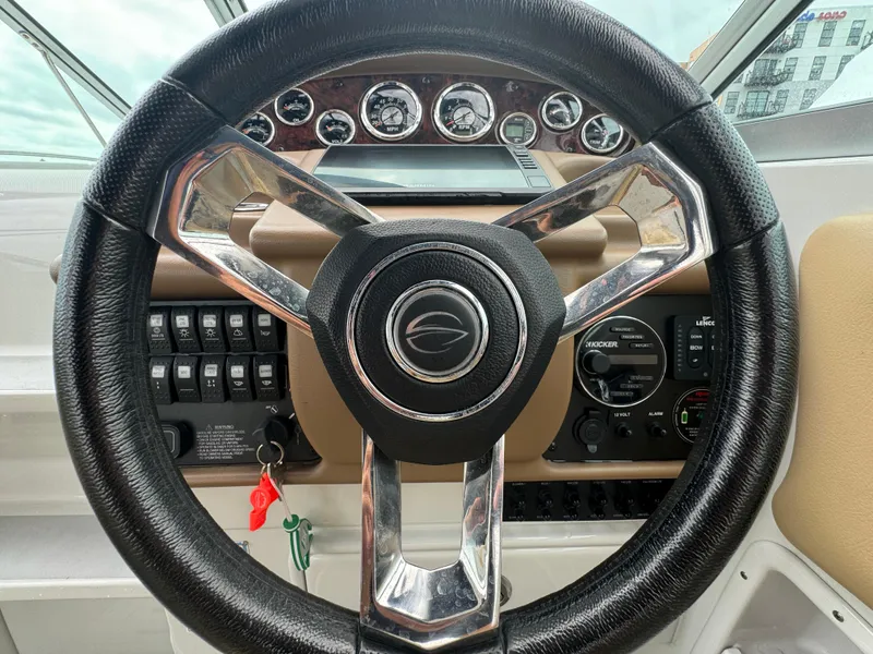 Slide: The Image of Steering wheel of 2020 Crownline 286 SC boat with dashboard controls. - 8