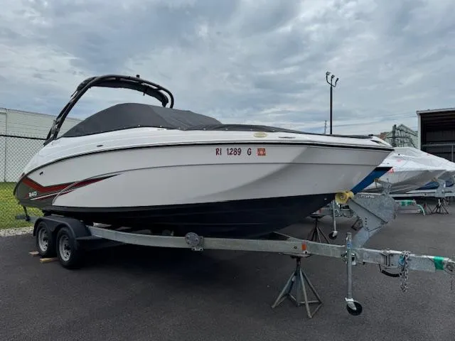 The Image of 2019 Yamaha AR240 boat on trailer, parked outdoors under cloudy sky. - 0