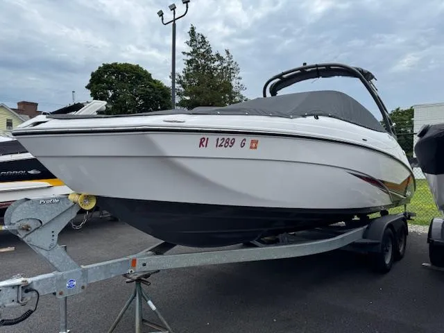 Slide: The Image of 2019 Yamaha AR240 boat on trailer, covered and parked outdoors. - 1