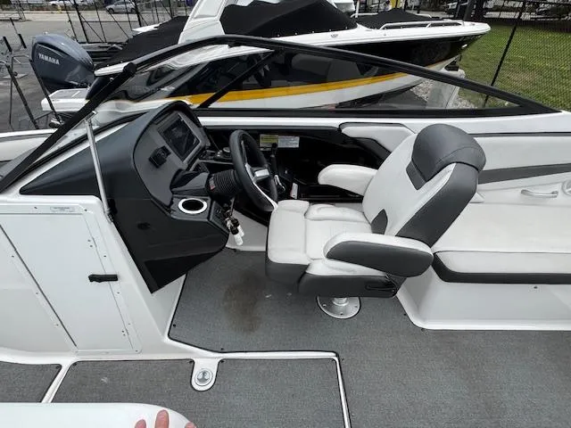 Slide: The Image of 2019 Yamaha AR240 boat interior with steering wheel and seating area. - 10