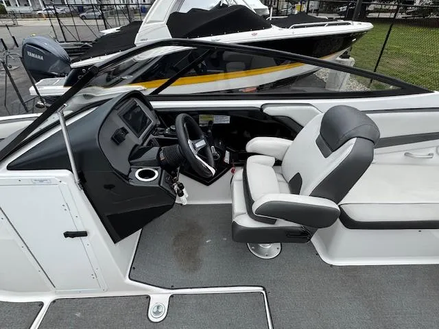Slide: The Image of 2019 Yamaha Boats AR240 cockpit with steering wheel and captain's chair. - 11