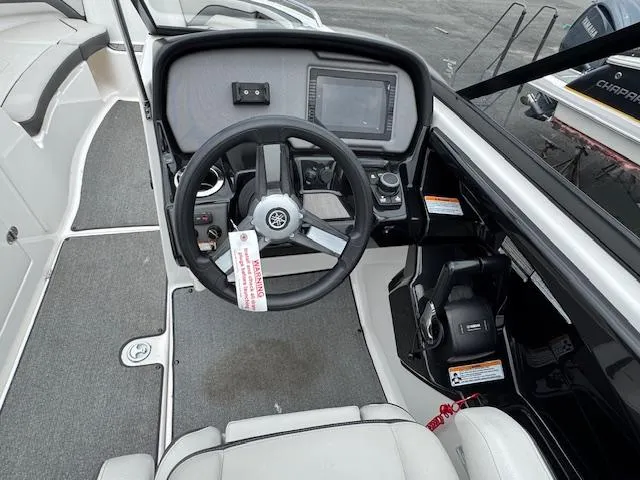 Slide: The Image of 2019 Yamaha AR240 boat cockpit with steering wheel and control panel. - 12