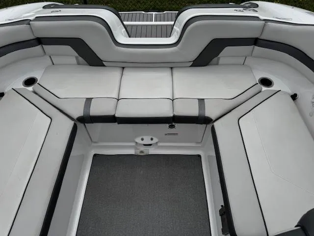 Slide: The Image of 2019 Yamaha Boats AR240 interior seating with gray and white upholstery. - 20