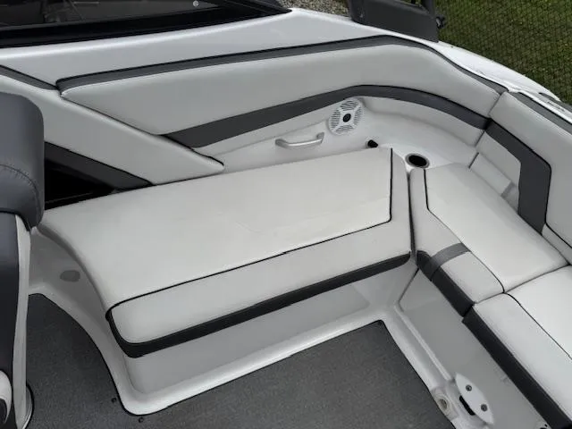 Slide: The Image of 2019 Yamaha AR240 boat interior with white and gray seating and speaker. - 21