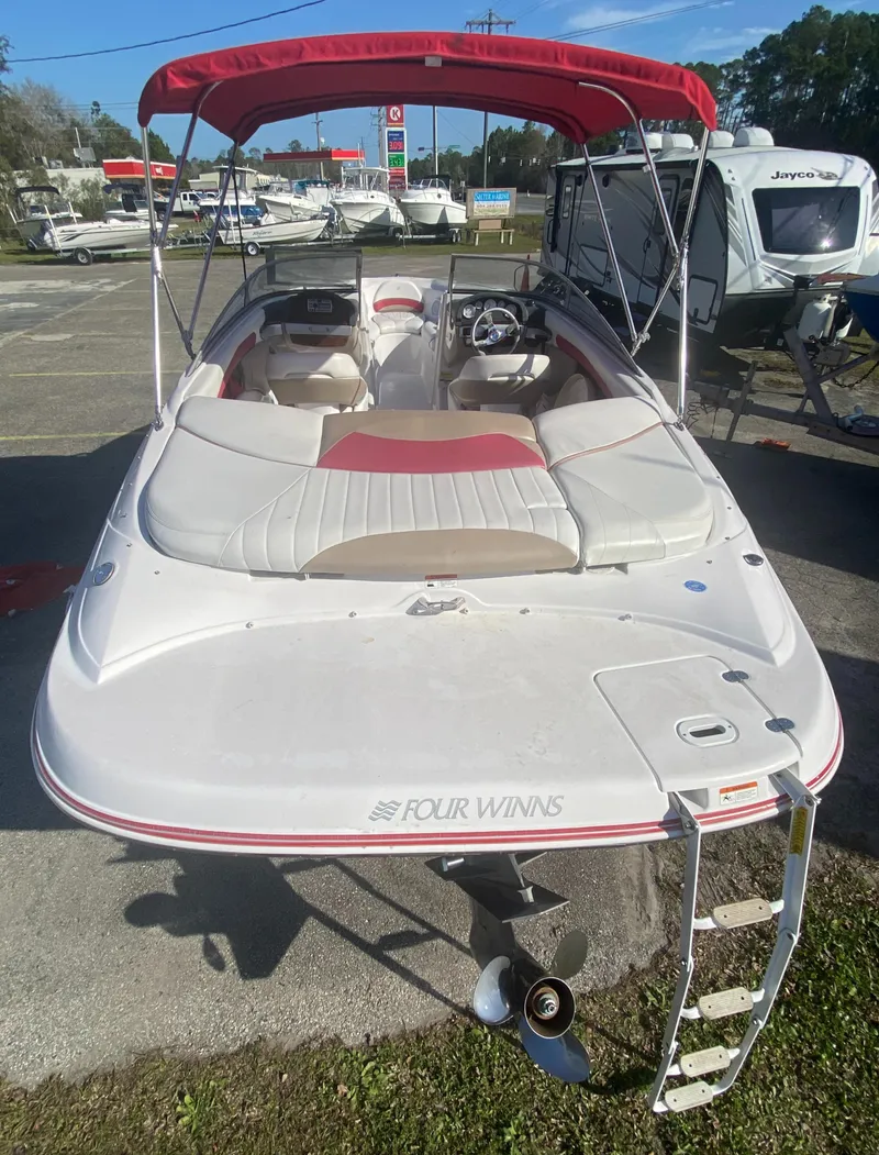 Slide: The Image of 2006 Four Winns 210 Horizon boat with red canopy and white seating. - 10