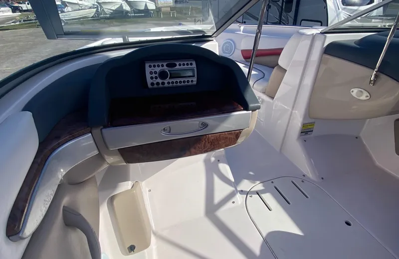 Slide: The Image of 2006 Four Winns 210 Horizon boat interior with dashboard and seating area. - 14