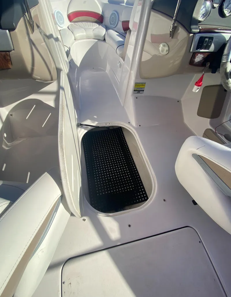 Slide: The Image of 2006 Four Winns 210 Horizon boat interior with open storage compartment. - 15