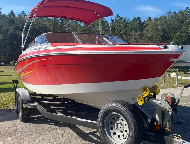 Slide: The Image of 2006 Four Winns 210 Horizon boat on trailer with red canopy. - 2