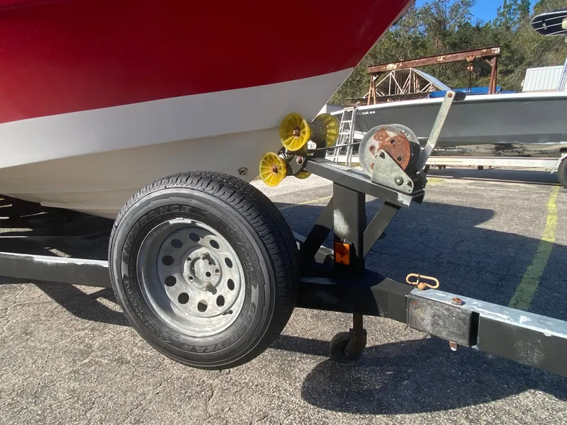 Slide: The Image of 2006 Four Winns 210 Horizon boat on trailer, close-up of wheel and hitch. - 3