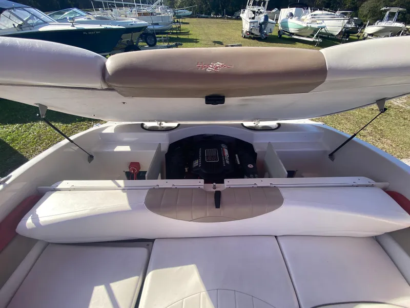 Slide: The Image of 2006 Four Winns 210 Horizon boat engine compartment with open hatch, showcasing interior details. - 4