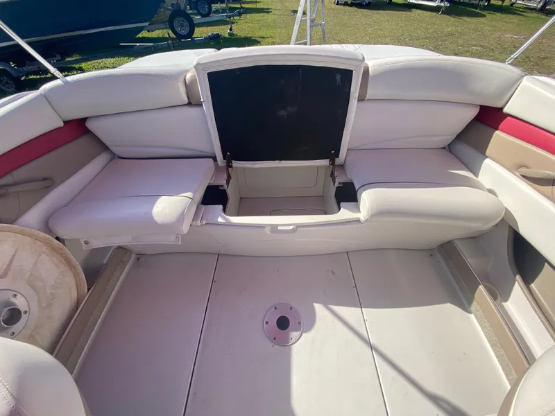 Slide: The Image of 2006 Four Winns 210 Horizon boat interior with white seating and storage compartment. - 7