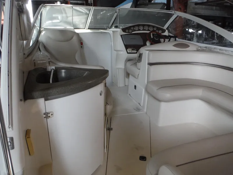 Slide: The Image of Interior of 2002 Doral 310se boat with seating and helm. - 10