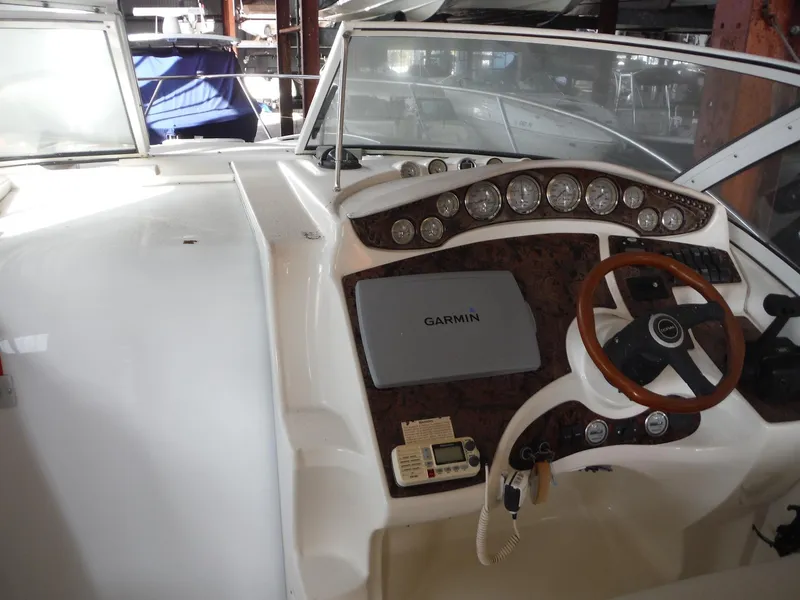 Slide: The Image of 2002 Doral 310se boat dashboard with Garmin navigation system and wooden steering wheel. - 11