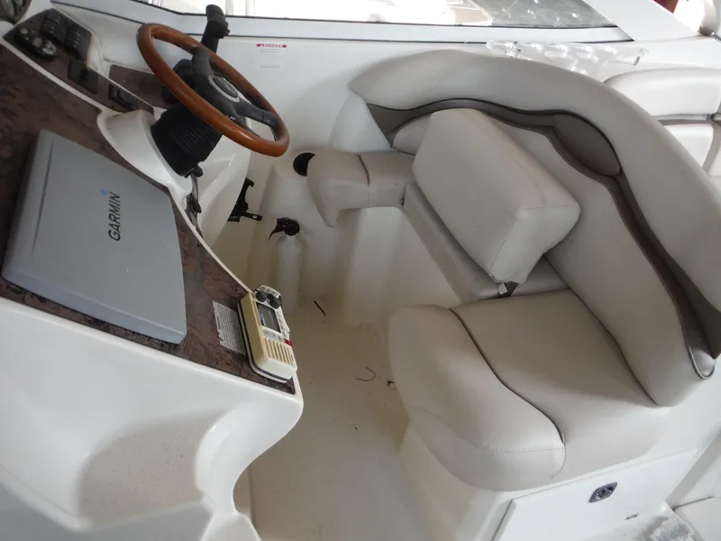 Slide: The Image of 2002 Doral 310se boat interior with steering wheel and seating area. - 13