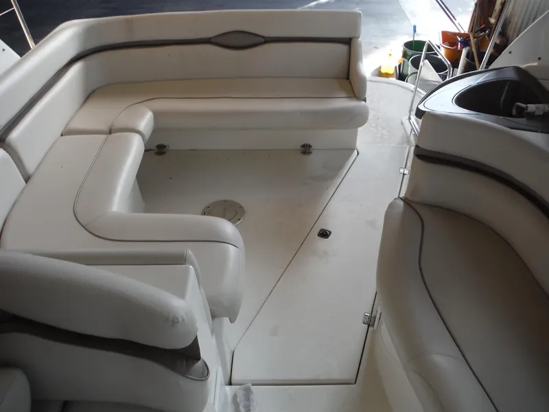 Slide: The Image of 2002 Doral 310se boat interior with white seating and compact layout. - 14