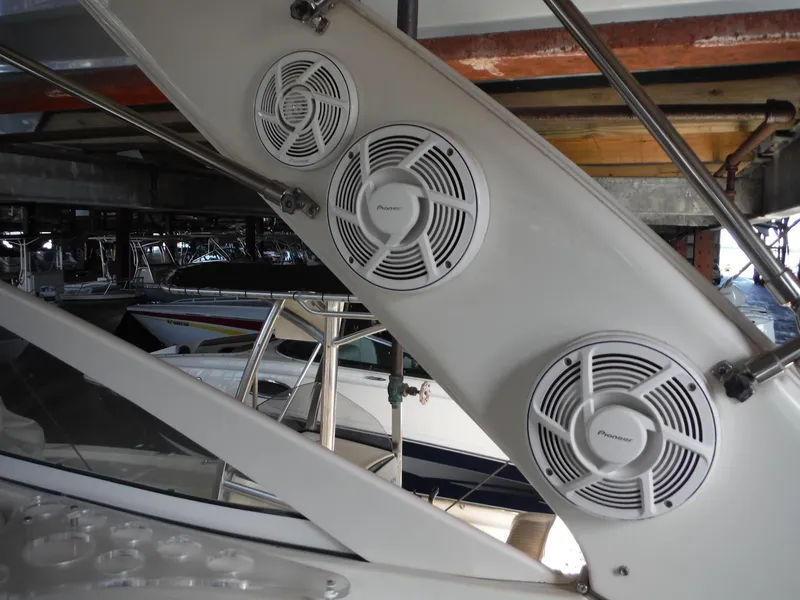 Slide: The Image of Doral 310se 2002 boat with mounted speakers in a marina setting. - 15