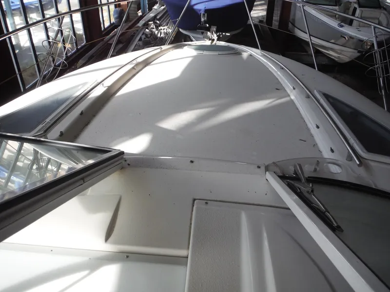 Slide: The Image of 2002 Doral 310se boat deck with open hatch, indoor storage setting. - 16