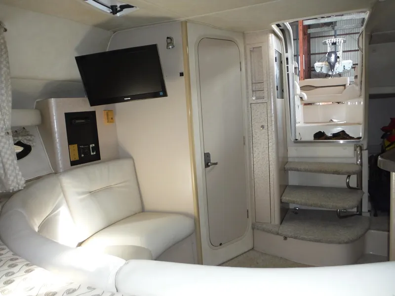 Slide: The Image of Interior of 2002 Doral 310se boat with TV, seating, and stairs. - 21