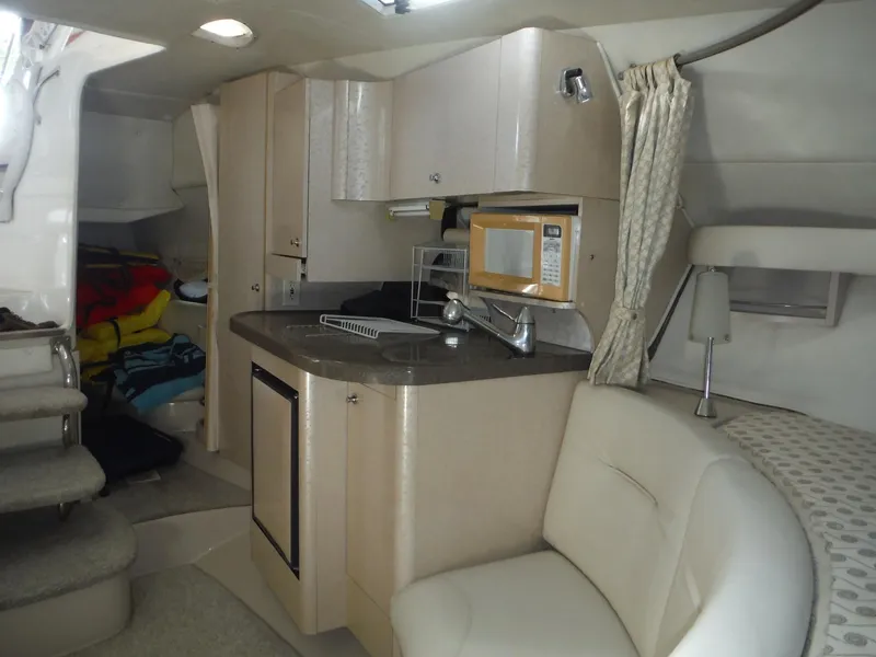 Slide: The Image of Interior of 2002 Doral 310se boat with kitchenette and seating area. - 22