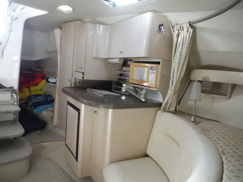 Slide: The Image of Interior of 2002 Doral 310se boat with kitchenette and seating area. - 23