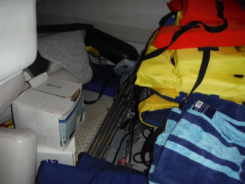 Slide: The Image of Interior of 2002 Doral 310se boat with life jackets and towels. - 27