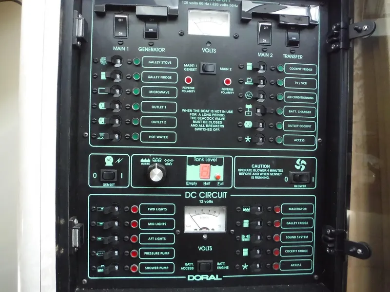 Slide: The Image of Control panel of a 2002 Doral 310se boat, featuring various switches and indicators. - 28