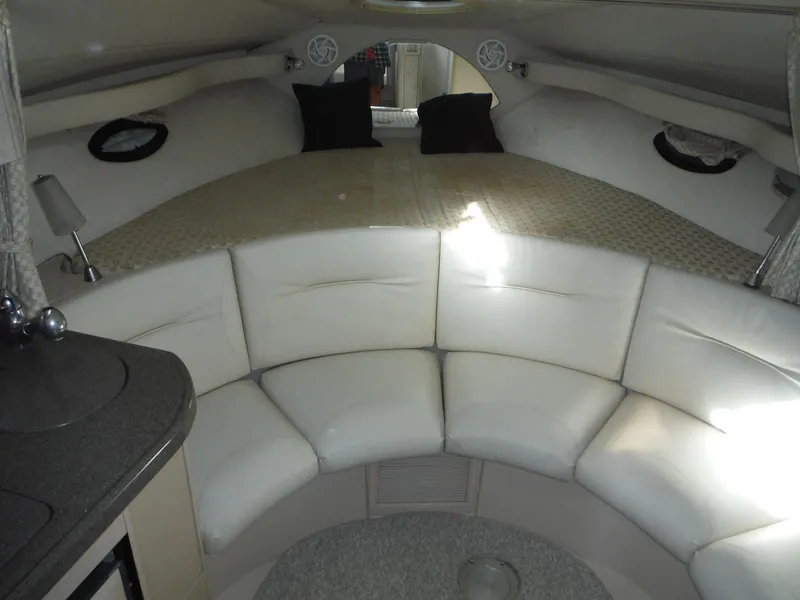 Slide: The Image of Interior of 2002 Doral 310se boat with circular seating and cozy sleeping area. - 29