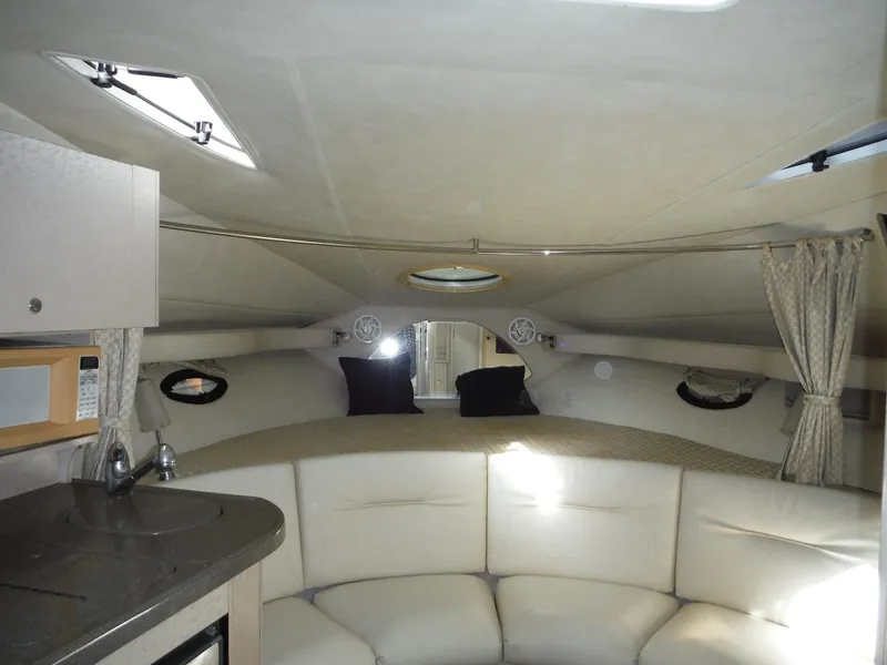 Slide: The Image of Interior of 2002 Doral 310se boat with cozy seating and kitchenette. - 30