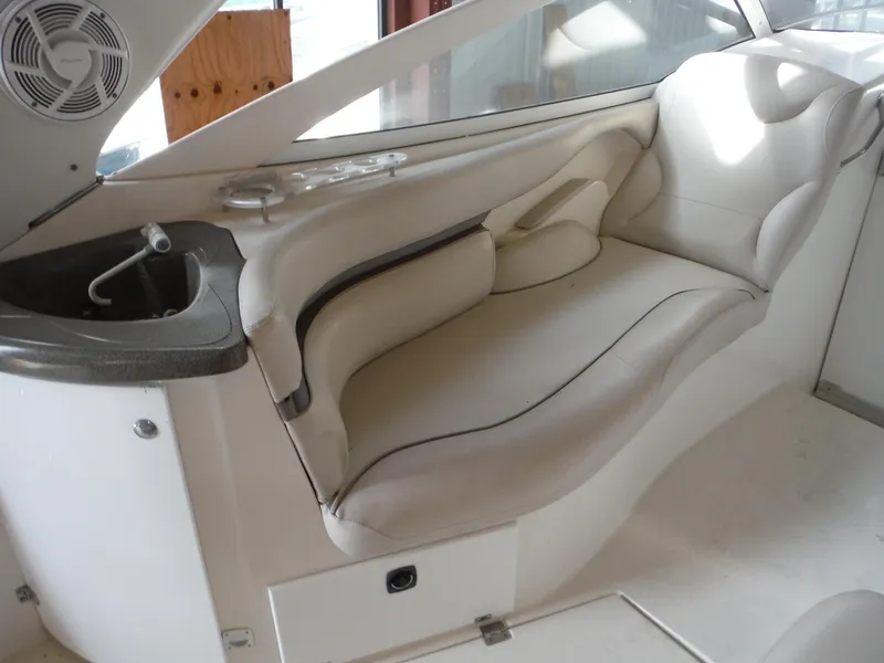 Slide: The Image of Interior seating of 2002 Doral 310se boat with white upholstery and built-in sink. - 32